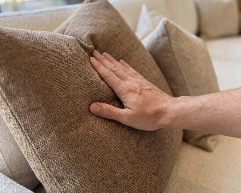 Hand pressing into a soft textured Haven cushion